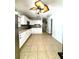 Updated kitchen features sleek white cabinets, granite countertops, and modern stainless steel appliances at 8210 Marigold Ave, Tampa, FL 33614