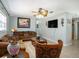 Traditional style living room featuring a ceiling fan, neutral paint colors, and tile flooring at 8210 Marigold Ave, Tampa, FL 33614