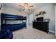 Inviting bedroom with a bunk bed, TV, neutral colors, and plenty of space for rest and play at 8314 Capstone Ranch Dr, New Port Richey, FL 34655