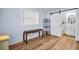 Bright bedroom with wood-look flooring, a barn door to the bathroom, and light blue walls at 9082 141St St, Seminole, FL 33776