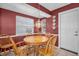 Cozy dining area featuring a round wooden table, seating for four, and natural light from the window at 9082 141St St, Seminole, FL 33776