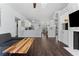 Open-concept kitchen flowing into the living area with white cabinets and dark wood floors at 968 Edgehill Dr, Palm Harbor, FL 34684