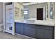 Bathroom with dark cabinets, a square sink and white shelves at 1093 Muirfield Ct, Tarpon Springs, FL 34688