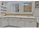 Bathroom with double sinks, a skylight and white cabinets at 1093 Muirfield Ct, Tarpon Springs, FL 34688