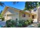 Charming home with a two-car garage, landscaped yard, and beautiful curb appeal on a sunny day at 1093 Muirfield Ct, Tarpon Springs, FL 34688