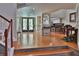 Open foyer with hardwood floors, leading to a spacious living area and an open-concept kitchen at 1093 Muirfield Ct, Tarpon Springs, FL 34688