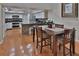 The dining area overlooks modern kitchen with stainless appliances and granite countertops at 1093 Muirfield Ct, Tarpon Springs, FL 34688