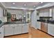 Bright kitchen with granite counters, stainless steel appliances, and hardwood floors at 1093 Muirfield Ct, Tarpon Springs, FL 34688