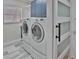 A laundry room featuring a side-by-side washer and dryer, with sliding barn door at 1093 Muirfield Ct, Tarpon Springs, FL 34688