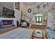 Elegant living room showcasing a stone fireplace, high ceilings, and staircase to the second level at 1093 Muirfield Ct, Tarpon Springs, FL 34688