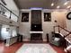 Well-lit living room with fireplace, hardwood floors, tall ceilings, and a second-floor balcony at 1093 Muirfield Ct, Tarpon Springs, FL 34688