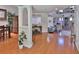 Spacious living room showcasing hardwood floors and an open layout to the dining area at 1093 Muirfield Ct, Tarpon Springs, FL 34688