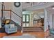 Open living space showcasing a split-level design and staircase with white railings at 1093 Muirfield Ct, Tarpon Springs, FL 34688