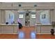 Bright living room featuring hardwood floors, detailed trim, and expansive shelving at 1093 Muirfield Ct, Tarpon Springs, FL 34688