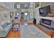 Spacious living room with hardwood floors, a fireplace, and an open view to the upper level at 1093 Muirfield Ct, Tarpon Springs, FL 34688