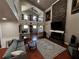 Open concept living room with a brick fireplace and vaulted ceilings at 1093 Muirfield Ct, Tarpon Springs, FL 34688