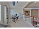 Upstairs office area with views of living area, modern desk, and bookshelf at 1093 Muirfield Ct, Tarpon Springs, FL 34688