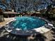 Community pool with clear blue water, surrounded by chairs for residents to relax in the sun at 1093 Muirfield Ct, Tarpon Springs, FL 34688