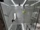 Luxurious shower with marble tile, glass enclosure, and recessed niche for toiletries at 1093 Muirfield Ct, Tarpon Springs, FL 34688