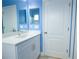 Beautiful bathroom showcasing modern vanity and framed mirror with blue walls at 12720 Whitney Meadow Way, Riverview, FL 33578