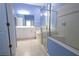 Bright primary bathroom with double sinks, soaking tub, and glass enclosed shower at 12720 Whitney Meadow Way, Riverview, FL 33578