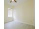Bright bedroom features a ceiling fan, window, and light-colored walls and flooring at 12720 Whitney Meadow Way, Riverview, FL 33578