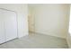 Bright, neutral bedroom with tile floors, closet, and ample natural light at 12720 Whitney Meadow Way, Riverview, FL 33578