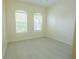 Serene bedroom with two windows letting in natural light and light, vinyl flooring at 12720 Whitney Meadow Way, Riverview, FL 33578