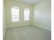 Serene bedroom with two windows letting in natural light and light, vinyl flooring at 12720 Whitney Meadow Way, Riverview, FL 33578