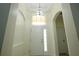 Bright foyer featuring a chandelier and beautiful tile flooring at 12720 Whitney Meadow Way, Riverview, FL 33578