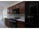 Modern kitchen showcasing stainless steel appliances and sleek, dark cabinetry at 12720 Whitney Meadow Way, Riverview, FL 33578