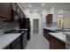 Modern kitchen featuring dark cabinets, stainless steel appliances, and stone backsplash at 12720 Whitney Meadow Way, Riverview, FL 33578