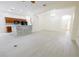 Open-concept living area connects kitchen and living room with views of the front door at 12720 Whitney Meadow Way, Riverview, FL 33578