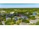 A picturesque aerial view of a multi-Gathering residential complex surrounded by lush greenery and a nearby lake at 13016 Sanctuary Cove Dr # 201, Temple Terrace, FL 33637