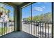 Screened balcony with view of palm trees and parking area at 13016 Sanctuary Cove Dr # 201, Temple Terrace, FL 33637