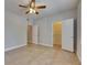 Spacious bedroom boasts tile floors, ceiling fan, and closet, offering comfort and style at 13016 Sanctuary Cove Dr # 201, Temple Terrace, FL 33637