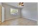 Neutral bedroom featuring tile floors, a ceiling fan, and a large window at 13016 Sanctuary Cove Dr # 201, Temple Terrace, FL 33637