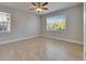 Bright bedroom with tile flooring, a ceiling fan, and windows offering natural light at 13016 Sanctuary Cove Dr # 201, Temple Terrace, FL 33637