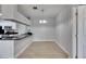 Dining area with tile floors, neutral paint, and view into the kitchen with black appliances at 13016 Sanctuary Cove Dr # 201, Temple Terrace, FL 33637