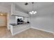 Dining area with tile floors, neutral paint, and view into the kitchen with black appliances at 13016 Sanctuary Cove Dr # 201, Temple Terrace, FL 33637