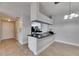 View of the dining area with tile floors, and a partial view into the kitchen with black appliances at 13016 Sanctuary Cove Dr # 201, Temple Terrace, FL 33637