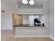 Bright kitchen featuring a breakfast bar with dark countertops and views to the hallway at 13016 Sanctuary Cove Dr # 201, Temple Terrace, FL 33637