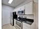Kitchen view highlighting stainless steel appliances and granite countertops at 13016 Sanctuary Cove Dr # 201, Temple Terrace, FL 33637