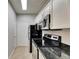 A view of the kitchen featuring stainless steel appliances and tile flooring at 13016 Sanctuary Cove Dr # 201, Temple Terrace, FL 33637