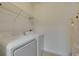 Efficient laundry room featuring a washer, dryer, and storage shelf at 13016 Sanctuary Cove Dr # 201, Temple Terrace, FL 33637