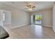 Open living area with tile floors and sliding doors that open to an outdoor space at 13016 Sanctuary Cove Dr # 201, Temple Terrace, FL 33637