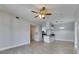 Spacious living area with tile flooring and a view into the kitchen with white cabinets at 13016 Sanctuary Cove Dr # 201, Temple Terrace, FL 33637