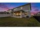 Expansive backyard with a covered patio, well-maintained lawn, and space for outdoor activities at 1439 Gopher Loop, Tarpon Springs, FL 34689