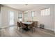 Elegant dining room with modern chandelier, stylish chairs, and natural light, perfect for Gathering meals at 1439 Gopher Loop, Tarpon Springs, FL 34689