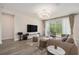 Comfortable living room featuring a large TV, plush seating, and a serene view of the outdoor space at 1439 Gopher Loop, Tarpon Springs, FL 34689
